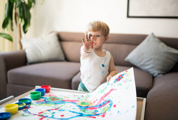 Finger painting. Close-up. Fingers of children's hands in bright paint. Early development. Hobby.