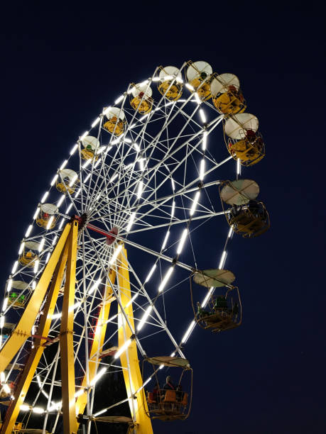 istock Illuminated ferris wheel at night against a deep blue sky 2185516733