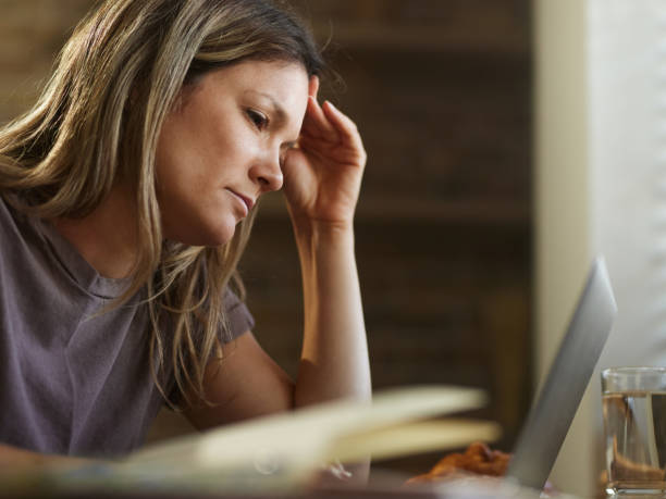 istock Displeased woman reading a problematic e-mail on laptop at home. 2185516808