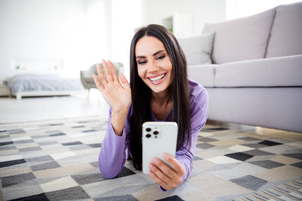 istock Charming young woman in a trendy pullover using a smartphone at home during daylight 2185518362