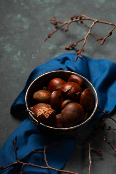 istock A bowl with edible chestnuts stands on a blue cloth 2185521956