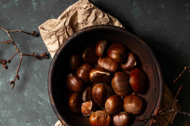 istock Edible chestnuts in a wooden bowl 2185521993