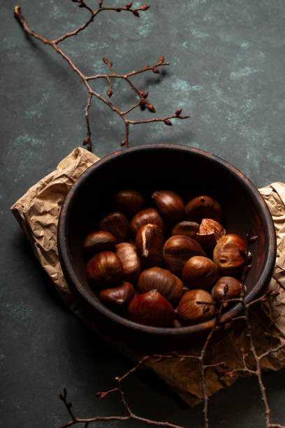 istock Edible chestnuts in a wooden bowl 2185521995