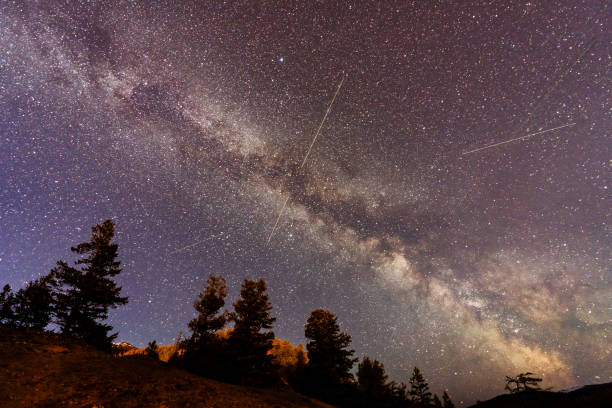 istock Milky Way and trees silhouette under a clear starry night sky. Real photos. 2185524346