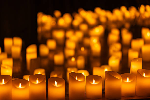 blurred symphonic orchestra on stage with lots of candles