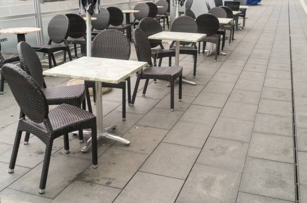 istock Empty outdoor cafe tables and chairs during rain 2185526814