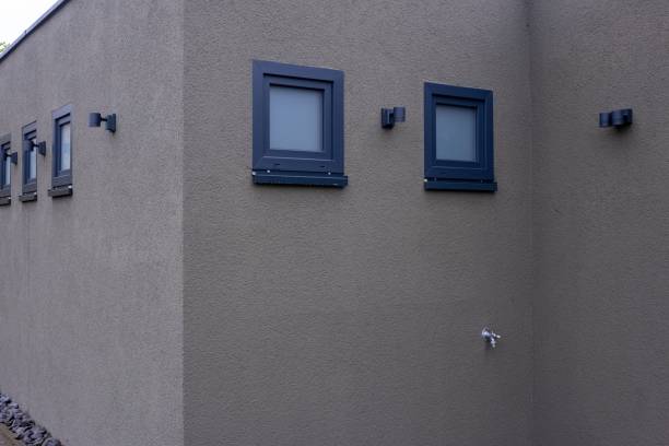 istock Modern house exterior showing plaster walls and dark framed windows 2185526997