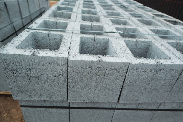 istock Construction concrete block. Industrial production of building cement pressed materials. Concrete Cinder Blocks. Vibration-pressed hollow building block. 2185528447