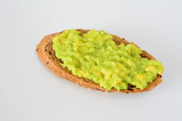 Creamy, delicious and healthy avocado toast for lunch or snack is a trendy food selection, Avocados pack high nutrition, healthy fats and high fiber, served with black peeper and cilantro.