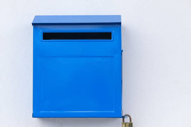 istock Close-up blue color iron mailbox on square shape that installed on white concrete wall 2185529983