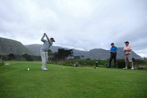 istock Golfer swinging golf club on lush green course 2185530196