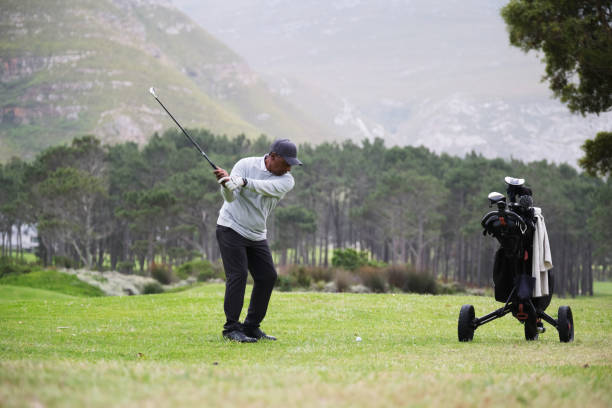istock Golfer concentrating while playing his shot from the fairway 2185530809