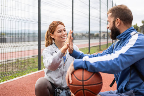 Young Duo Shares a High Five During Basketball Game