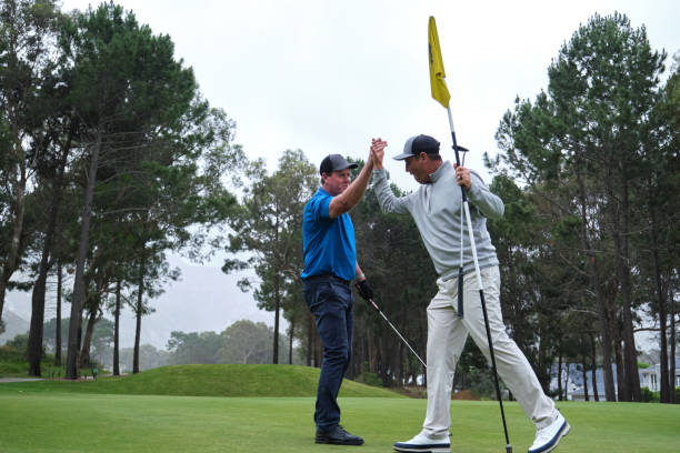 istock Golfers give each other a high five after a great putt 2185531558