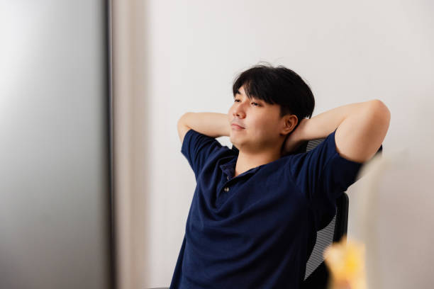 Young man relaxing in a modern office space while contemplating his work