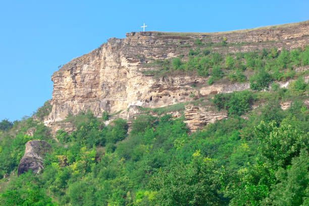 Rocky cliff with a large cross placed at the top