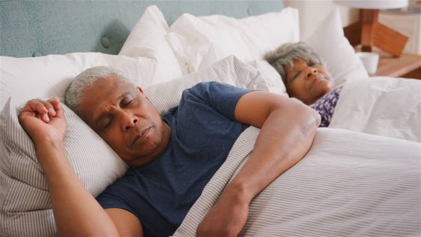 istock Senior Couple At Home Sleeping In Bed In Morning 2185532199