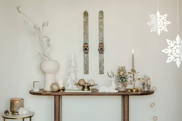 istock Rustic console table with winter decorations, vintage skis, and snowflake ornaments. Perfect for a cozy holiday atmosphere. 2185532299