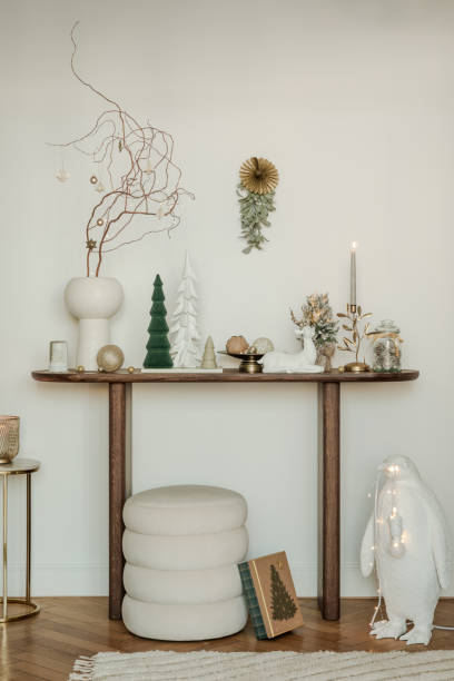 istock Rustic console table with winter decorations, vintage skis, and snowflake ornaments. Perfect for a cozy holiday atmosphere. 2185532388
