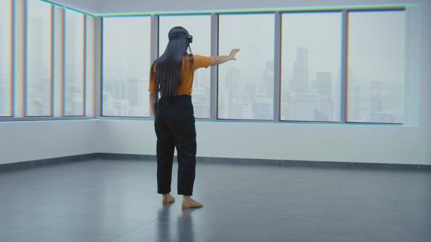 istock Asian female designer in VR headset creates interior in office room in 3D virtual space 2185534023