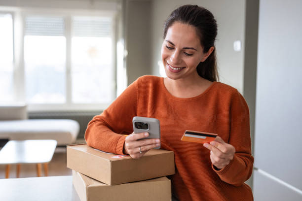 istock Woman with her packages and credit card 2185534057