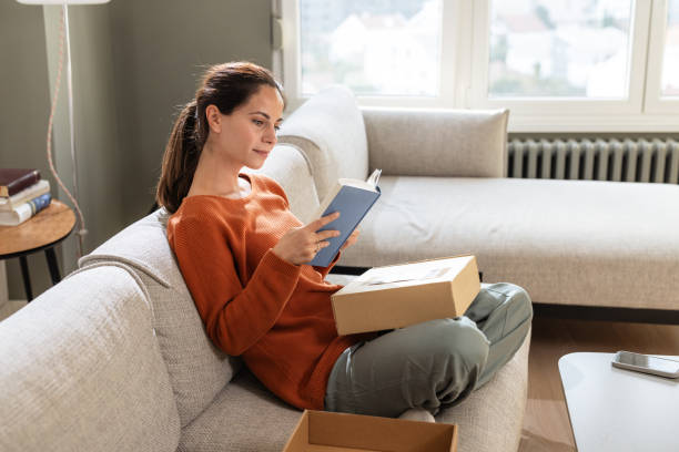 istock Modern shopper enjoying her new purchase at home 2185534082