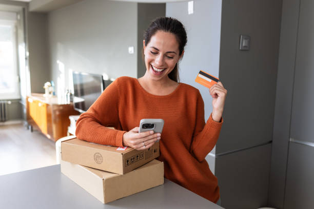 istock A cheerful woman making an online purchase at home 2185534095