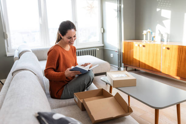 istock Unboxing joy: Woman opening her delivery at home 2185534098