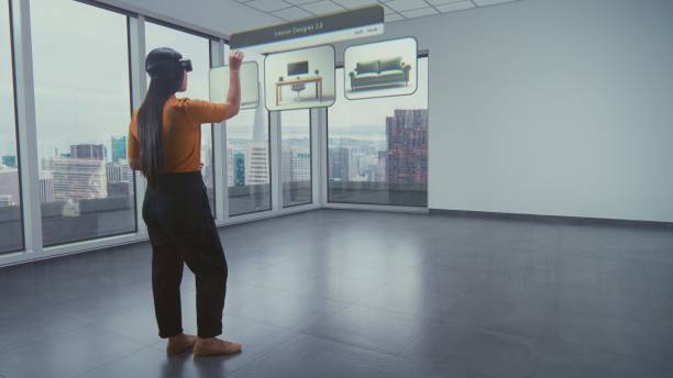 Asian female designer uses AR interior design app to arrange office workspace or apartment