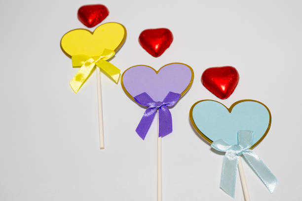 valentine concept using ribbons and chocolate on isolated white