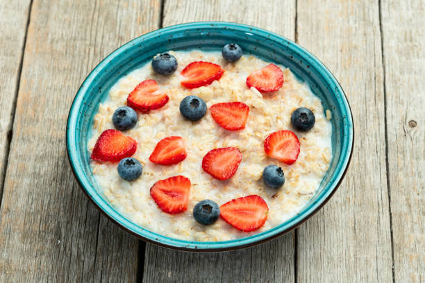 istock Homemade breakfast . Oatmeal with milk and berries . Top view 2185537721