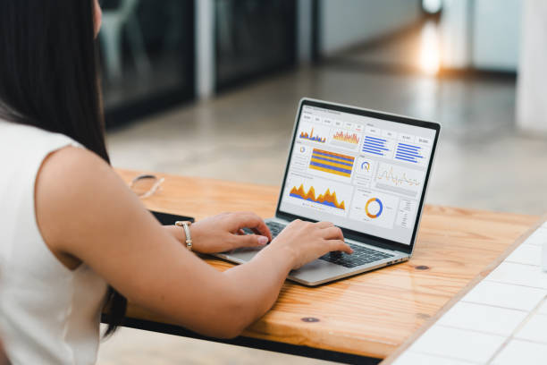 istock Businesswoman or an accountant team are analyzing data charts, graphs, and a dashboard on a laptop screen in order to prepare a statistical report and discuss financial data in an office. 2185537892