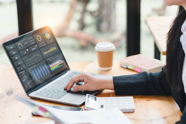 istock Businesswoman or an accountant team are analyzing data charts, graphs, and a dashboard on a laptop screen in order to prepare a statistical report and discuss financial data in an office. 2185537918