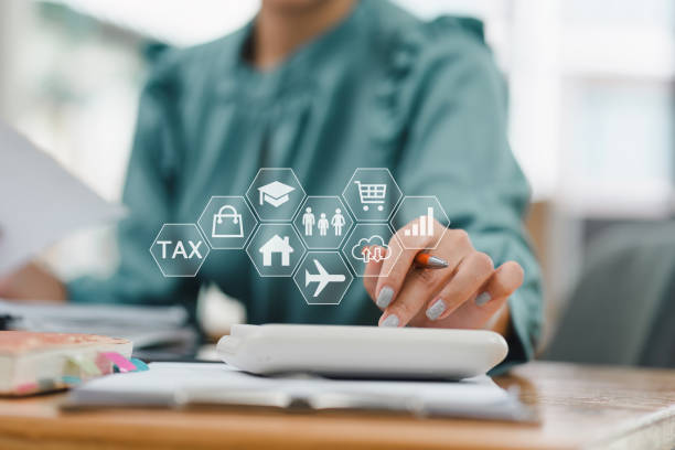 istock Efficiently managing finances, woman uses calculator while surrounded by various financial icons representing tax, education, shopping, and travel 2185537927
