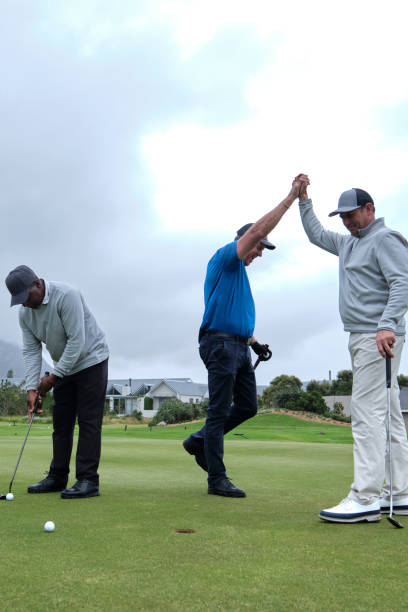istock Golfers high five after the one player makes a great putt 2185540453