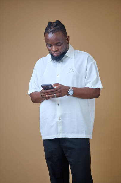 istock African man holding a phone 2185543039