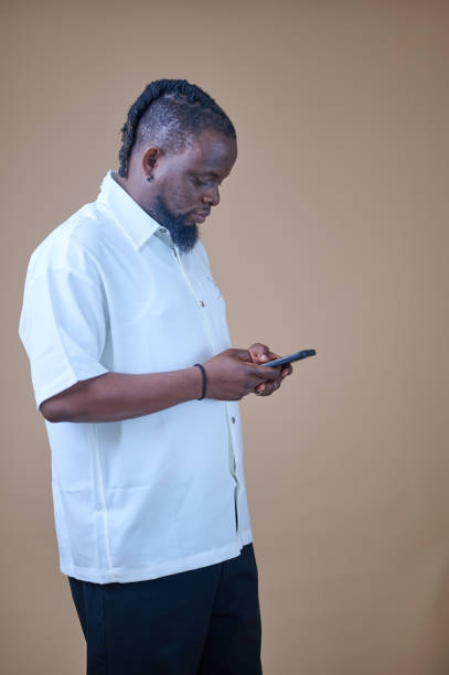istock African man holding a phone 2185543054