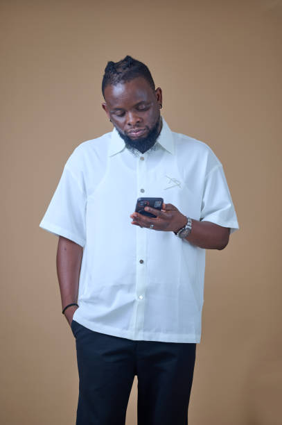 istock African man holding a phone 2185543102