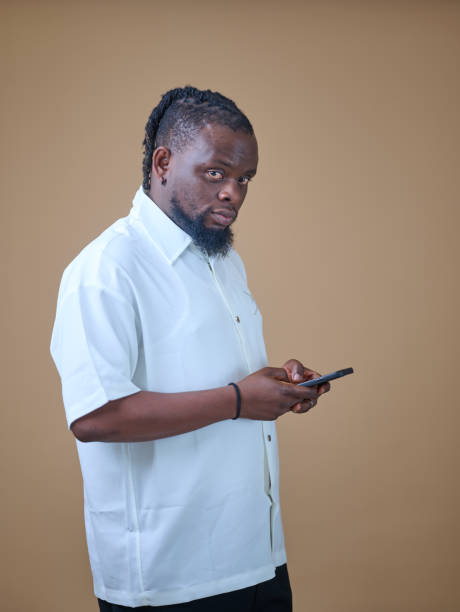 istock African man holding a phone 2185543105