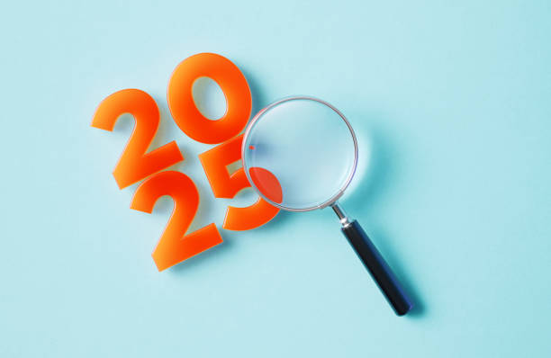 istock Magnifier And Orange Colored 2025 On Blue Background 2185543641