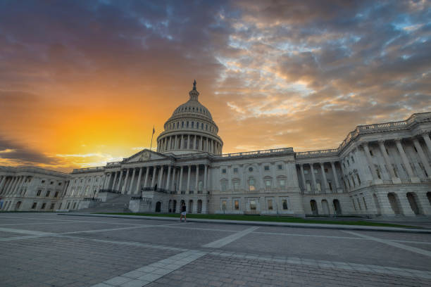 istock Sun shining over United States Capitol Building at sunset 2185544433