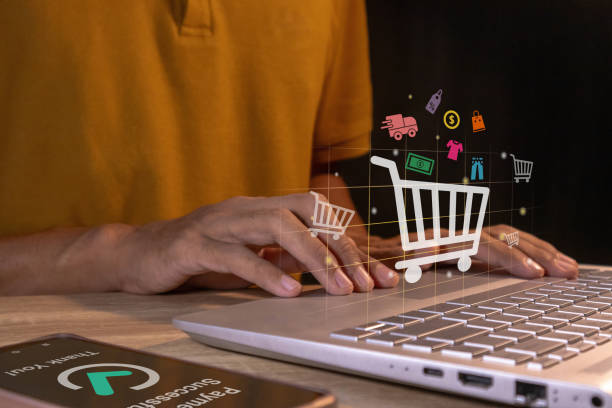 istock Man using a laptop for online shopping and making payment on smartphone. Online shopping and e-commerce technology internet concept. 2185545482
