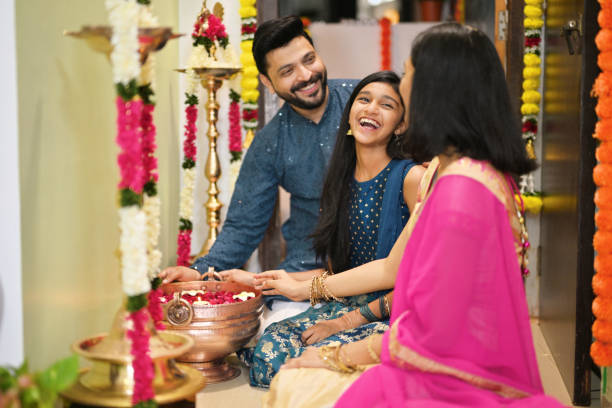 istock Father and his two daughters decorating a lamp (diya) in an Urli during Diwali celebration 2185545990