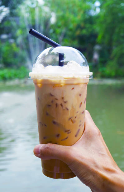 Hand Holding a Cup of Mouthwatering Iced Coffee