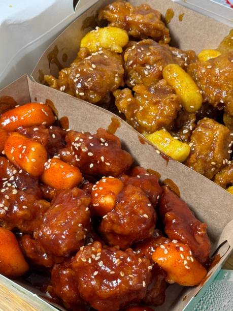 Crispy Korean fried chicken, perfectly glazed with a sweet and spicy sauce. Ideal for food photography and menus, showcasing the irresistible crunch and flavor of this beloved dish.
