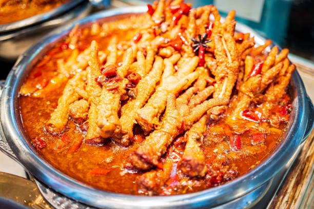 A plate of enticing spicy chicken feet soaked in a rich chili and spice sauce, exuding an irresistible aroma