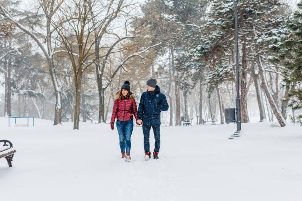 istock Young Couple Walking In A Snowy Forest In Winter 2185549948