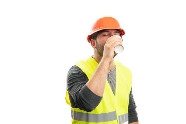 istock Constructor man sipping coffee from paper cup as morning concept 2185549972