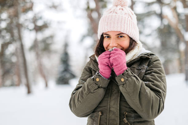 istock Young Woman Feeling Cold In A Snowy Forest 2185550042