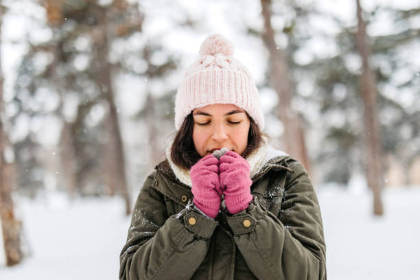 Young Woman Feeling Cold In A Snowy Forest